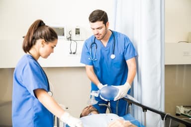Nursing student performing clinical patient care simulator training